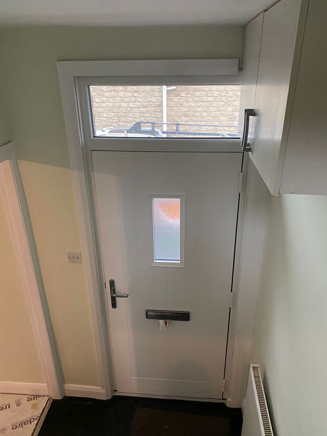 Part of Joseph O’Neill Decorating Contractors @jdcltd.info full house decorating project, this kitchen combines modern utility with bold sophistication. The matte charcoal grey wall provides a striking contrast to the white marble-look counter top and sleek black cabinetry, creating a sharp, modern finish. Copper-toned handles and stainless steel appliances elevate the aesthetic while maintaining functionality. Clean paint lines and careful edging around fixtures showcase professional craftsmanship.