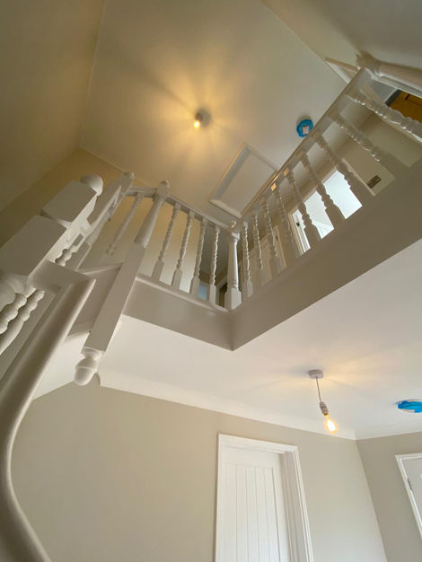 Stairwell Glow-Up
A fresh perspective — modern lighting, soft taupe walls, and gleaming white banisters brighten this multi-level stairwell. The perfect blend of classic detailing and modern simplicity.