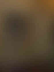 Pantry shelf with assorted jars and bottles, glowing candles, and a "Colman's Mustard" tin. Warm, vintage kitchen setting.