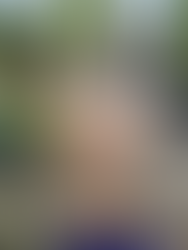 Our Golden Retriever puppy, Arthur, is sitting in the courtyard at Haddo House looking away from the camera.