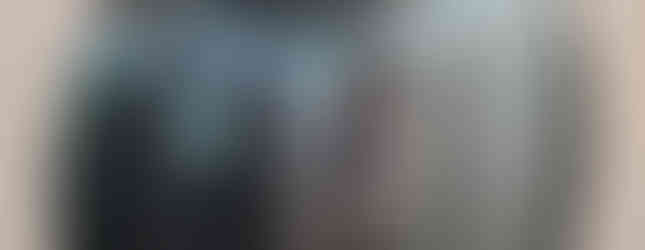 Victorian jailer mannequin in plaid cloak holding a lantern inside a dim stone cell. Text: "VICTORIAN JAILER" and historical info above.