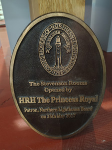 Bronze plaque on wood reads: "The Stevenson Rooms opened by HRH The Princess Royal, Patron, Northern Lighthouse Board, on 25th May 2017."