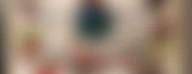 Tapestry features a figure in tartan, red boots, holding a spear, surrounded by colorful patches depicting nature and patterns. Artwork is framed.