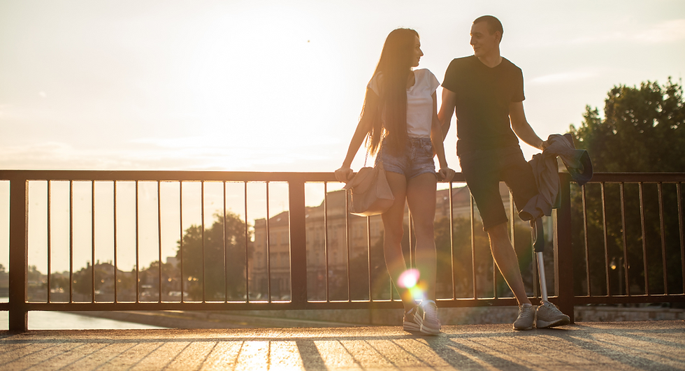 woman and man standing on a bridge together