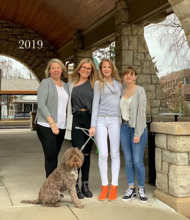 mother, three daughters and dog at train station