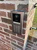Hikvision intercom device on brickwall