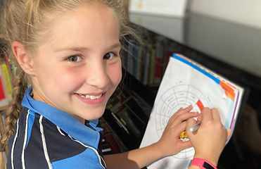 Girl, smiling, sitting at a piano