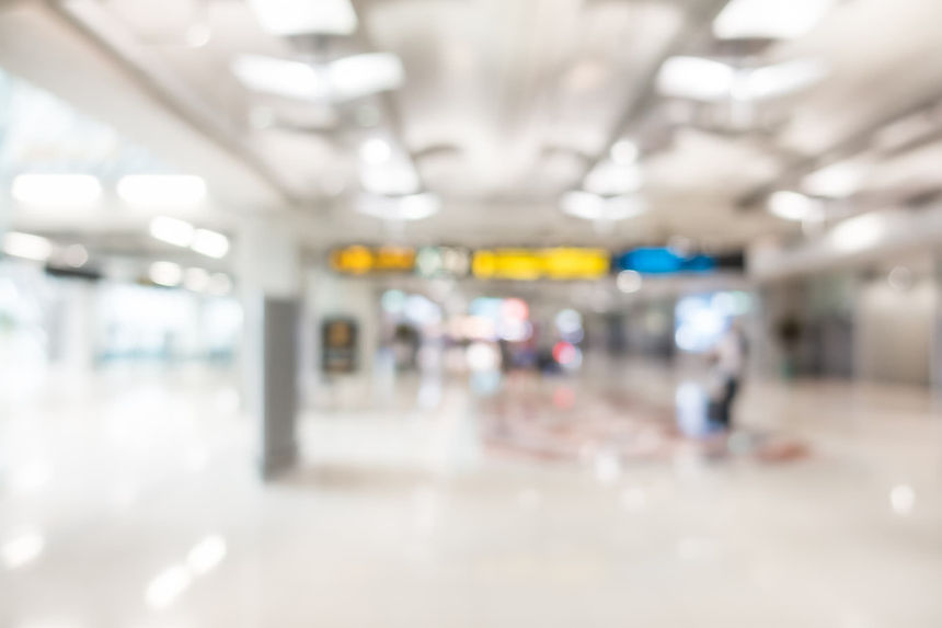 inside view of a busy UK airport terminal with passengers and luggage