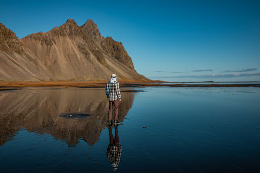 Iceland: Man Standing On Icelandic Beach During Low Tide