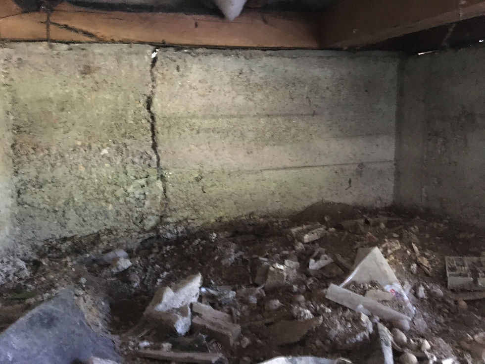 A concrete perimeter footing showing a large vertical crack and structural displacement.