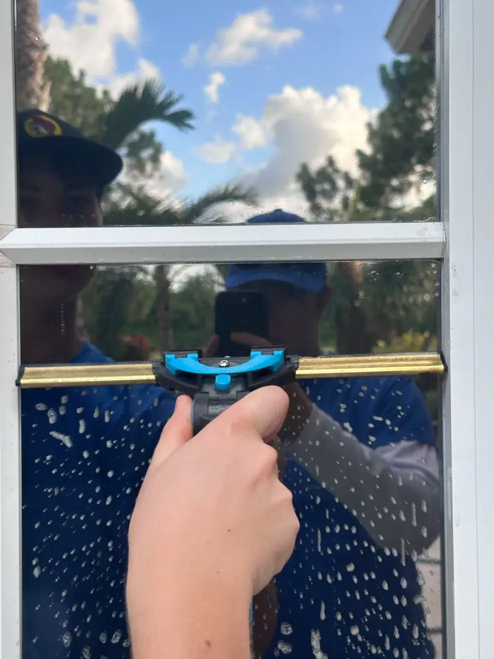 Photo of us using a squeegie on a real window 