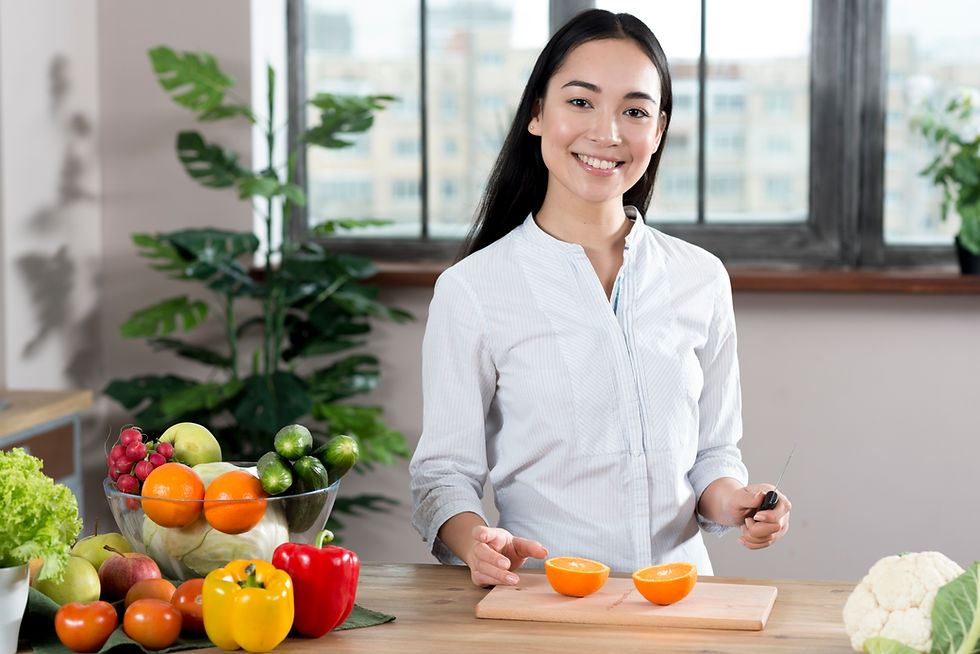 portrait-young-woman-standing-near-kitchen-counter-with-different-types-vegetables-fruits.