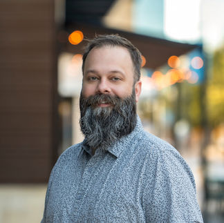 Professional headshot taken at Legacy West in Plano, capturing a confident and approachable brand image.