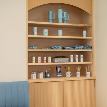 Built-in retail shelving display inside orthodontic office in Frisco TX captured with commercial interior photography.
