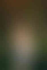 DFW senior session showcasing a confident senior portrait surrounded by flowers and greenery