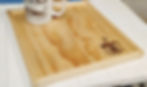 Thumbnail: Angled, left view of handmade espresso coffee serving board with an engraved silhouette graphic of a steaming hot espresso coffee cup. The beautiful, natural wood grain is stunning thanks to a clear, food safe finish.