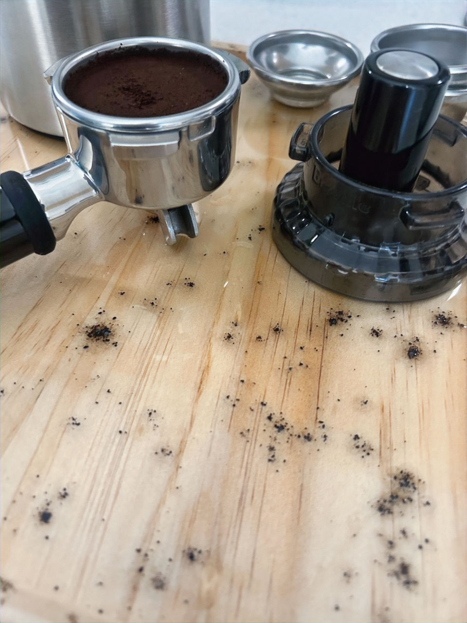 Thumbnail: close view of espresso coffee board top with porta filter. details of real espresso coffee grounds in food safe finish