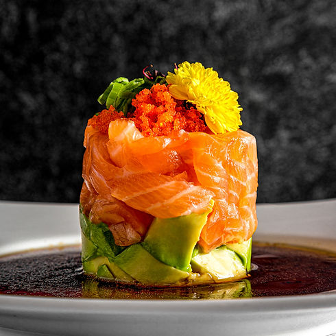 Professional food photography of gourmet salmon tartare with avocado, tobiko, and edible flower, captured for restaurant menu and social media marketing in Toronto.