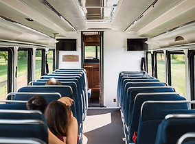 white charter bus with passengers