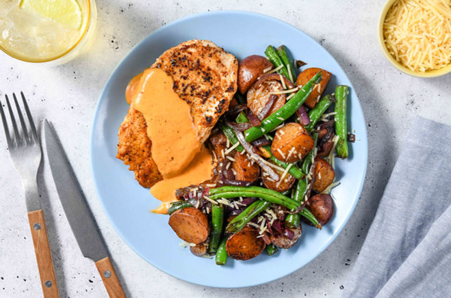 hree-quarter angle plated chicken with green beans and grain on blue plate commercial food photography Crawford Captures