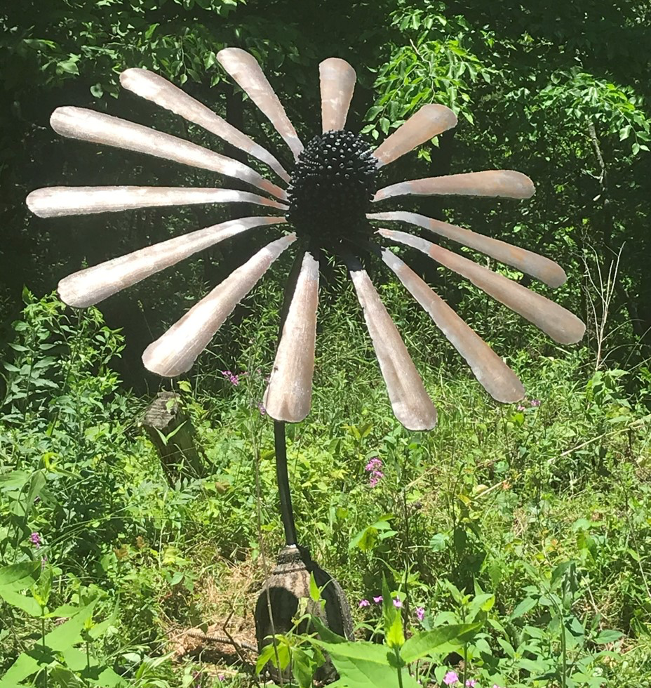 The Coneflower. 
Made from a large argon welding tank. The top of the tank becomes the base, The cone is made from the tank cap and the petals are made from the sides of the tank.
Available and For Sale by order. 
