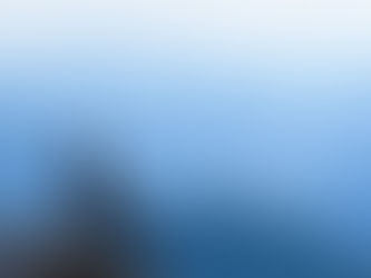 Woman sitting quietly on a mountain ledge — image for “Your Brain Is Not the Problem. Your Attention Is.”