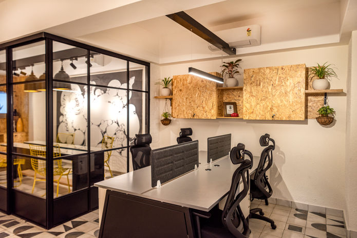 Black and white floor tiles with yellow highlights and a bold and out of the box look for Cab experience office in Needs Supermart