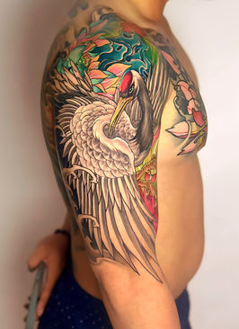 Japanese style crane tattoo on a shoulder and upper arm