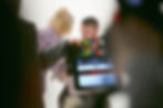 Woman preparing a man for filming an interview