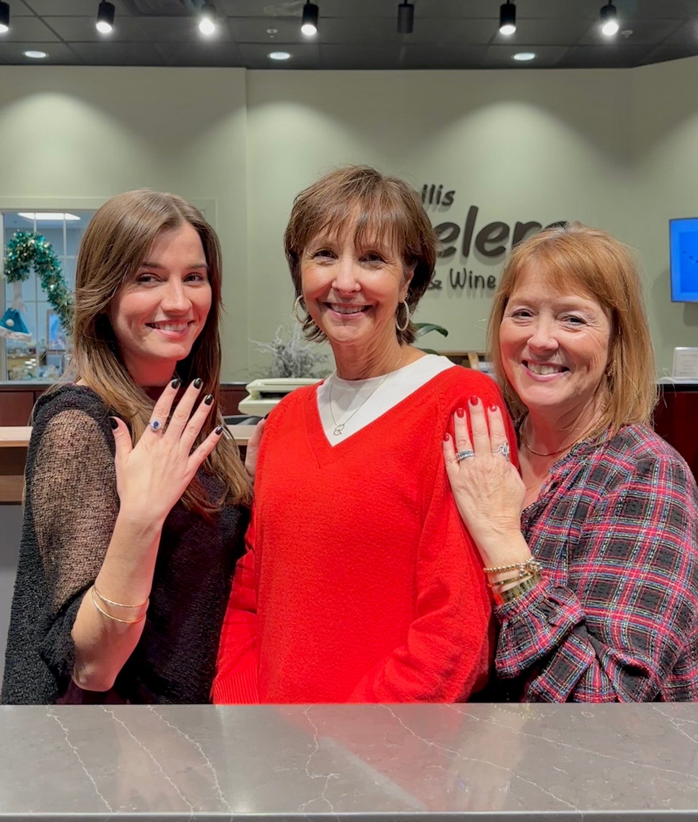 Staff at K. Hollis Jewelers posing with their favorite fine jewelry.