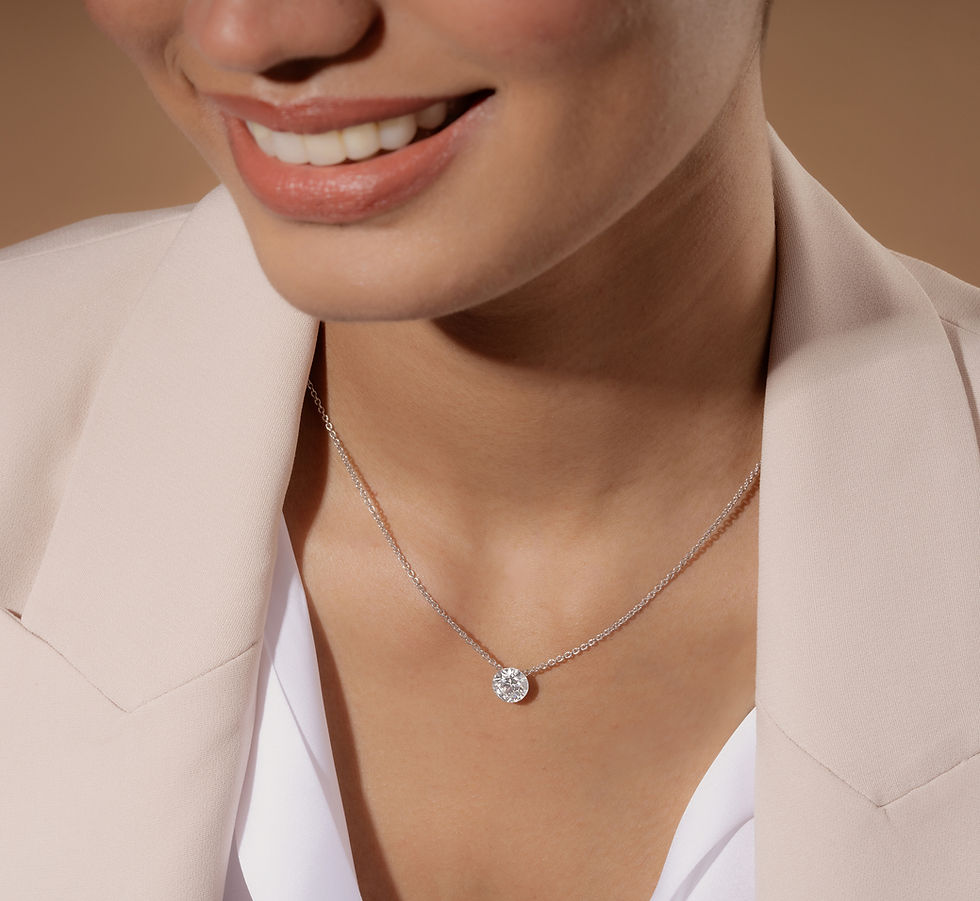 A woman wearing a classy solitaire diamond pendant by Bare Brilliance at K. Hollis Jewelers