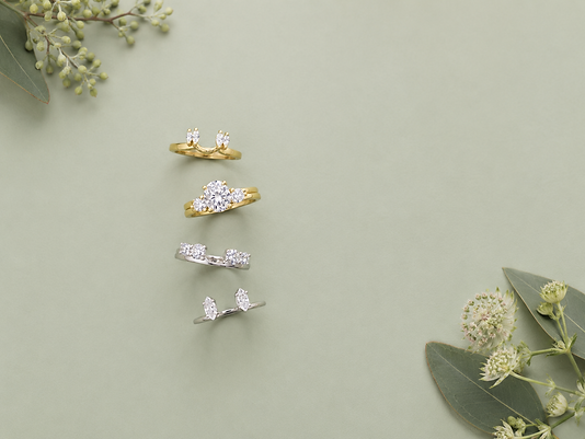 Vintage inspired engagement ring with a split shank setting and filigree details in yellow gold.