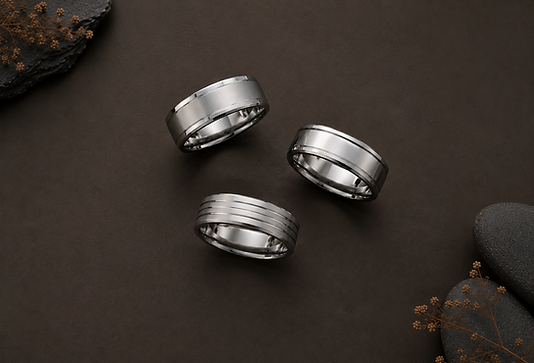 A finished custom engagement ring next to its wax mold and sketches