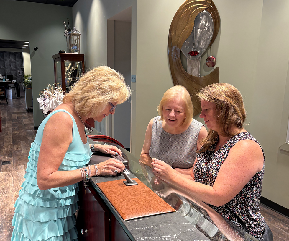 Karen Hollis shopping with two customers browsing our timeless Ti Sento line