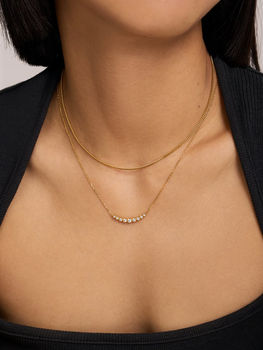 Ania Haie layered gold necklaces with curved row of clear stones