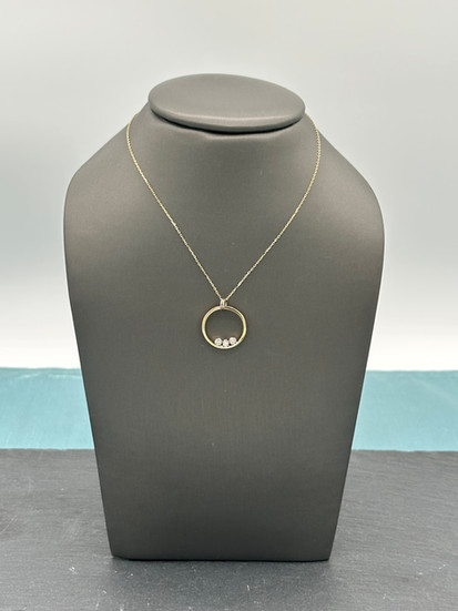 A three stone ring that has been redesigned into a pendant at K. Hollis Jewelers