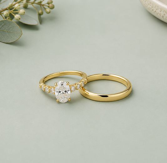 Timeless style three stone diamond engagement ring with a simple yellow gold band