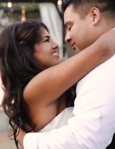Wedding film clip of a happy bride hugging her groom in Sacramento