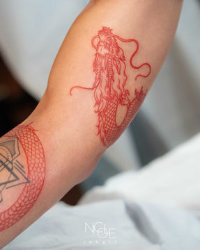 best fine line dragon tattoo wrapping around arm, done by Nicole in West Hollywood, CA