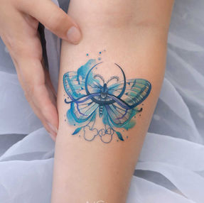 watercolor butterfly tattoo on arm done by female tattoo artist Nicole in West Hollywood, CA