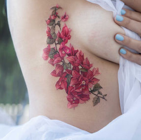 one of the best color floral tattoo on side of boob done by Nicole in West Hollywood, CA