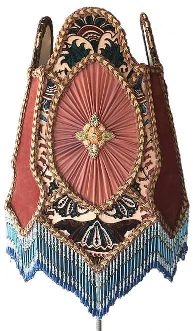 Handmade vintage-style lampshade with pleated pink panel, floral medallion, patterned fabric, braided trim, and blue beaded fringe.