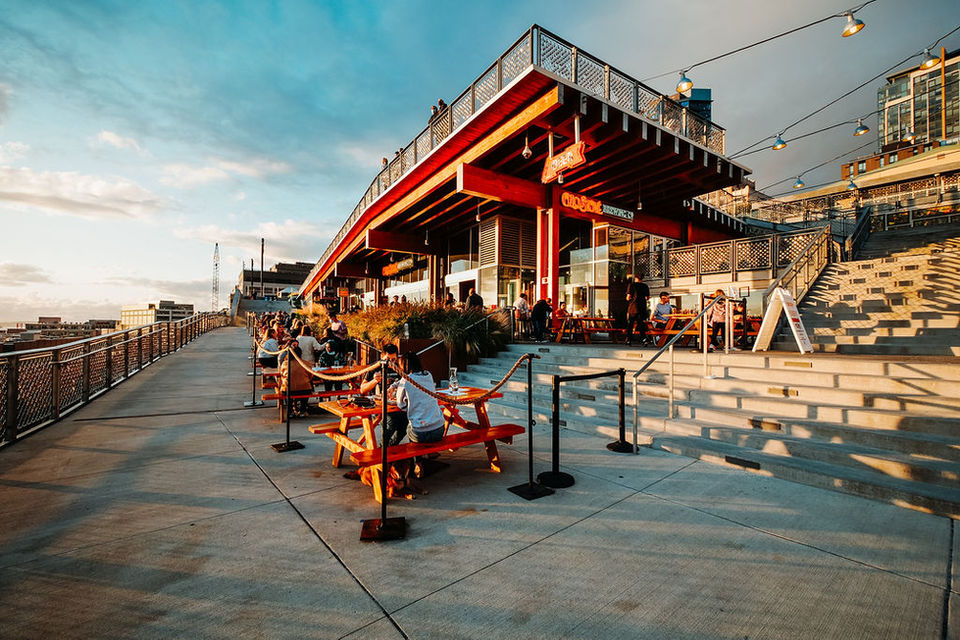 Outdoor restaurant patio on a boardwalk at sunset