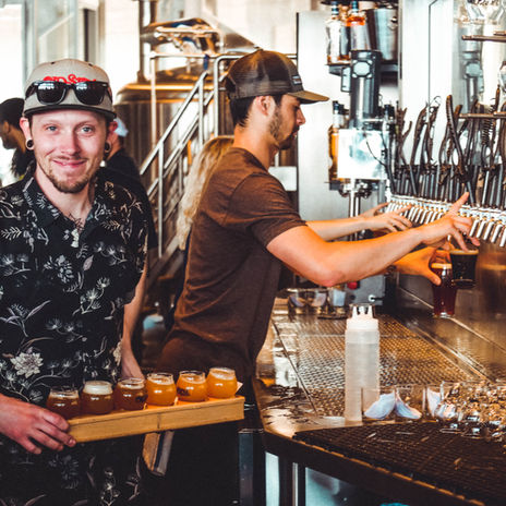Server with a flight of Old Stove Beers