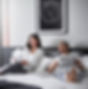 A comfortable husband and wife sitting on the bed in their comfortable bedroom.