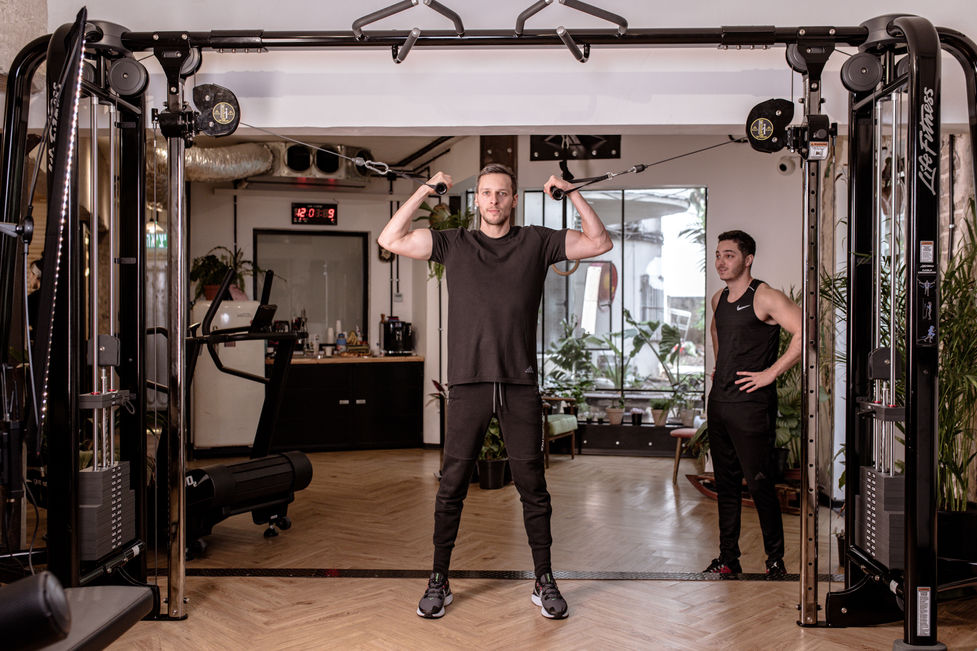 young man at he gym with trainer 