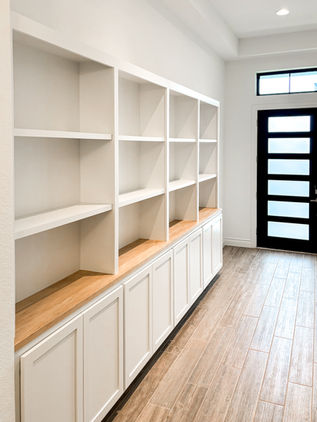 Custom entryway built-in cabinetry with solid maple top and adjustable shelving, crafted for a luxury home in New Braunfels, TX. Showcases transitional design and elevated storage solutions for refined Texas Hill Country interiors.