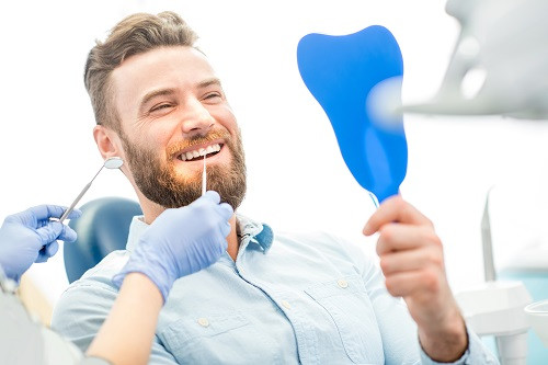 Man Checks Teeth