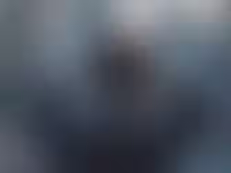 Executive experiencing cognitive dissonance and leadership stress while looking out a high-rise window, illustrating the internal conflict of selfish leadership.