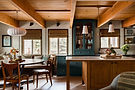 Open-plan dining and living area with wood beam ceiling and forest views at The Homewood West Shore Lake Tahoe